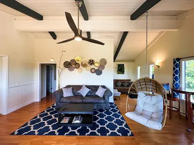 a living room with a couch and a ceiling fan at Hilltop Penthouse Cottage with Sweeping Views in Fallbrook
