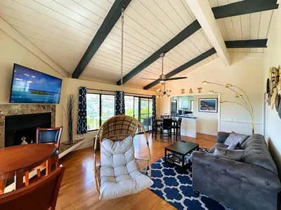 a living room with a couch and a table at Hilltop Penthouse Cottage with Sweeping Views in Fallbrook