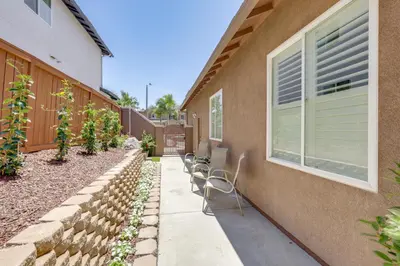 a patio with chairs next to a building at Private and Spacious Deluxe Rolling Hills Ranch Gem in Chula Vista