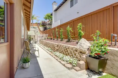 a patio with potted plants and a retaining wall at Private and Spacious Deluxe Rolling Hills Ranch Gem in Chula Vista