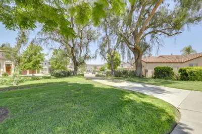 a yard with trees and a driveway at Private and Spacious Deluxe Rolling Hills Ranch Gem in Chula Vista