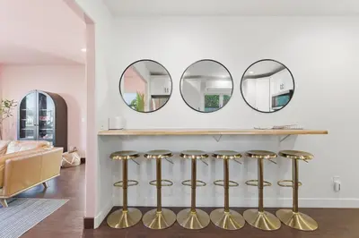 a living room with three mirrors on the wall at Condé Nast's top-rated Vacation home for 2 years running! in San Diego