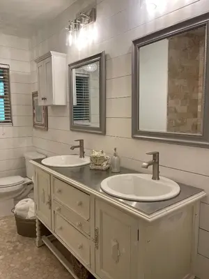 a bathroom with two sinks and a mirror and a toilet at Avocado House in El Cajon