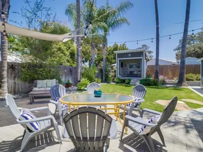 a patio with a table and chairs in a yard at Bay Park Gem - Fully Loaded in San Diego