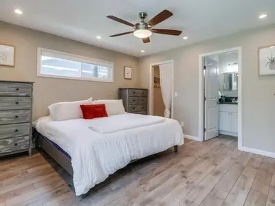a bedroom with a bed with a ceiling fan at Bay Park Gem - Fully Loaded in San Diego