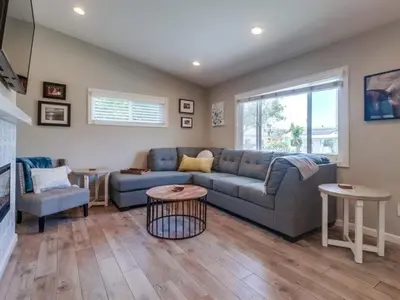 a living room with a blue couch and two tables at Bay Park Gem - Fully Loaded in San Diego