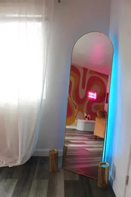 a mirror in a room with a colorful wall at Sol di Vito in San Diego