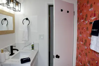 a white bathroom with a sink and a mirror at Sol di Vito in San Diego