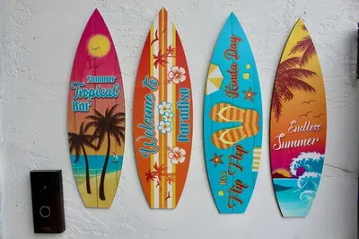 a group of four surfboards hanging on a wall at Sol di Vito in San Diego