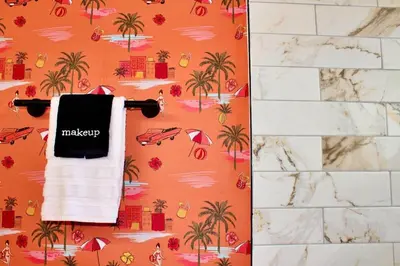 an orange wallpaper with palm trees and umbrellas and a towel at Sol di Vito in San Diego