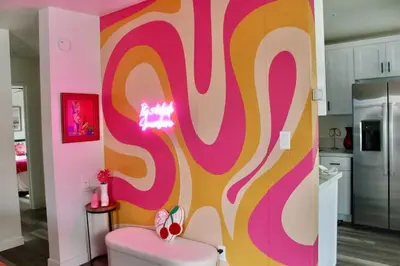 a kitchen with a pink and yellow wall at Sol di Vito in San Diego