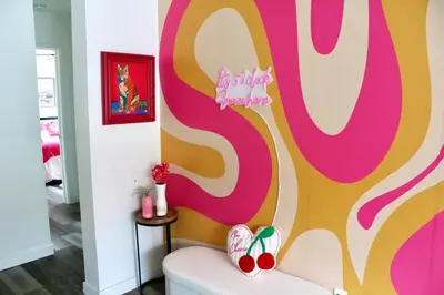 a living room with a pink and yellow wall at Sol di Vito in San Diego