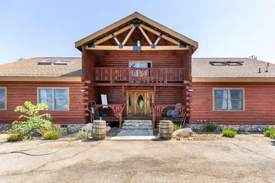 a log home with a porch and a deck at San Diego Getaway, Views Pool Hot Tub & Game Room in Valley Center