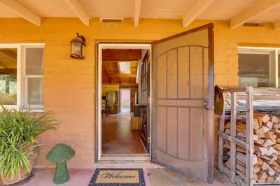 a front door of a house with a yellow wall at 4 Mi to Lake Wohlford Cabin in Escondido in Valley Center