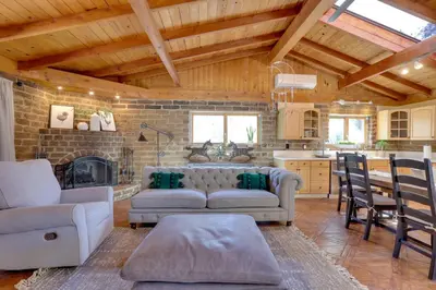 a living room with a couch and a table and a kitchen at 4 Mi to Lake Wohlford Cabin in Escondido in Valley Center