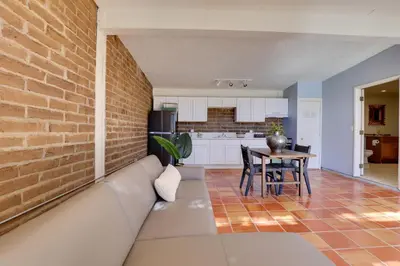 a living room with a couch and a brick wall at 5 Mi to Casino and Lake Home on Escondido Ranch! in Valley Center