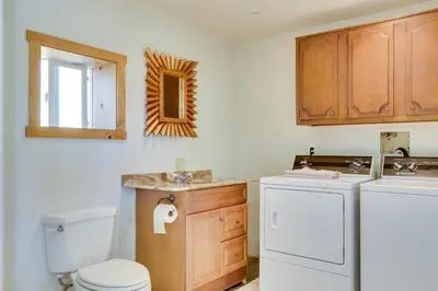 a bathroom with a toilet and a washer and dryer at 5 Mi to Casino and Lake Home on Escondido Ranch! in Valley Center