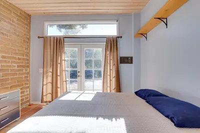 a bedroom with a bed and a large window at 5 Mi to Casino and Lake Home on Escondido Ranch! in Valley Center