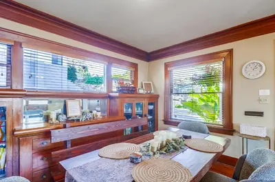 a dining room with a table and some windows at Sunny San Diego Golden Hill Home! Pet Friendly, near DT, Fully Stocked! in San Diego
