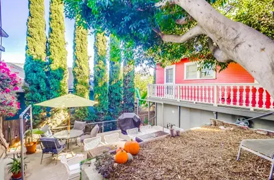 a patio with a table and chairs and a tree at Sunny San Diego Golden Hill Home! Pet Friendly, near DT, Fully Stocked! in San Diego