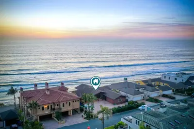 an aerial view of a house next to the ocean at Oceanfront Getaway - Ocean Views - Fire Pit - BBQ - Beach Access in Carlsbad
