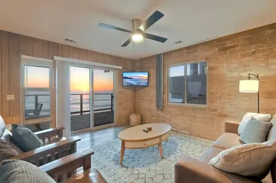 a living room with a couch and a ceiling fan at Oceanfront Getaway - Ocean Views - Fire Pit - BBQ - Beach Access in Carlsbad