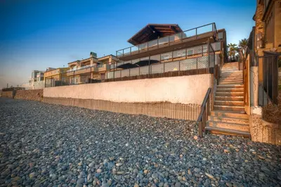 a building with stairs on the side of a street at Oceanfront Getaway - Ocean Views - Fire Pit - BBQ - Beach Access in Carlsbad