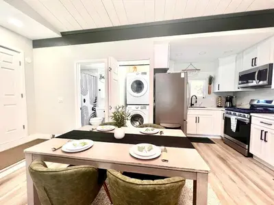 a kitchen with a table and chairs in a room at Half ACRE Lux Pool SPA with FIREPIT ARCADE Grill Sleeps 40 in El Cajon