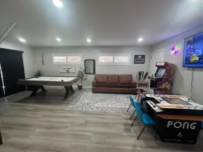 a living room with a pool table and a couch at Half ACRE Lux Pool SPA with FIREPIT ARCADE Grill Sleeps 40 in El Cajon