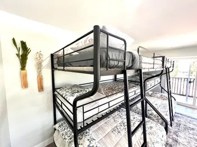 two black bunk beds in a room at Half ACRE Lux Pool SPA with FIREPIT ARCADE Grill Sleeps 40 in El Cajon
