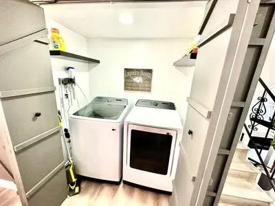 a small laundry room with a washer and dryer at Half ACRE Lux Pool SPA with FIREPIT ARCADE Grill Sleeps 40 in El Cajon