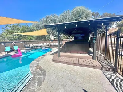 a swimming pool with a blue awning and a swimming pool at Half ACRE Lux Pool SPA with FIREPIT ARCADE Grill Sleeps 40 in El Cajon