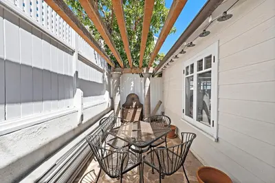 a patio with a table and chairs on a porch at Luxurious Seaside Escape-85 Steps to the Beach-Panoramic Ocean Views in Laguna Beach