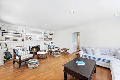 a living room with a couch and a fireplace at Luxurious Seaside Escape-85 Steps to the Beach-Panoramic Ocean Views in Laguna Beach