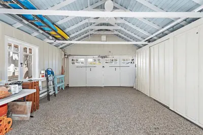 a large garage with white doors and a ceiling at Luxurious Seaside Escape-85 Steps to the Beach-Panoramic Ocean Views in Laguna Beach