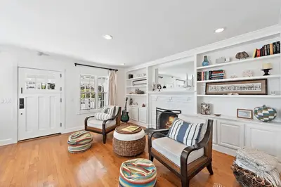 a living room with two chairs and a fireplace at Luxurious Seaside Escape-85 Steps to the Beach-Panoramic Ocean Views in Laguna Beach