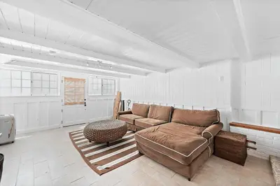 a living room with a couch and a table at Luxurious Seaside Escape-85 Steps to the Beach-Panoramic Ocean Views in Laguna Beach