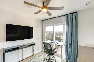 a living room with a flat screen tv and a desk at Balconies and Views Modern Abode in Poway! in Poway