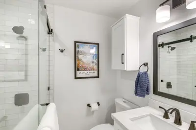 a white bathroom with a sink and a shower at Balconies and Views Modern Abode in Poway! in Poway