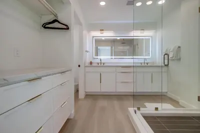 a bathroom with a glass shower and a sink at Sunset Path La Jolla Shores in San Diego