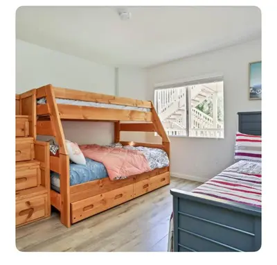a bedroom with a wooden bunk bed and a window at Ritz Pointe dr in Dana Point
