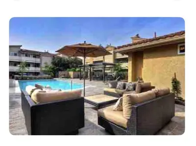 a swimming pool with two couches and an umbrella at Ritz Pointe dr in Dana Point
