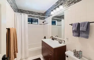 a bathroom with a sink and a toilet and a mirror at Autumn Room at Eaglenest Inn with Pool and SPA in Julian