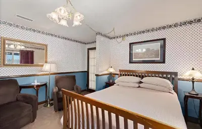 a bedroom with a bed and a couch and a chair at Autumn Room at Eaglenest Inn with Pool and SPA in Julian