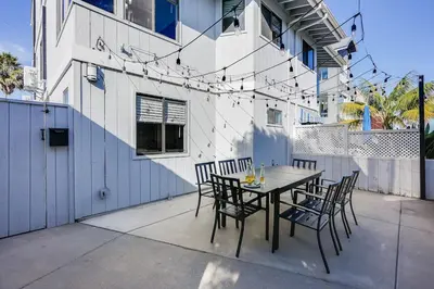 a table and chairs in front of a building at Luxury Meets Coastal Charm in North Mission Beach in San Diego