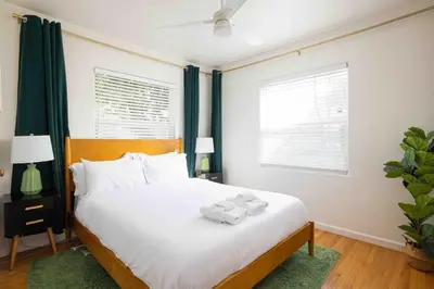 a bedroom with a bed with towels on it at Modern Retro Close to DT, Zoo, Parking, Hot Tub in San Diego
