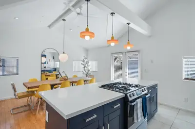 a kitchen and dining room with a stove top oven at Modern Retro Close to DT, Zoo, Parking, Hot Tub in San Diego