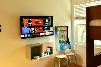 a room with a flat screen tv on the wall at Modern Retro Close to DT, Zoo, Parking, Hot Tub in San Diego