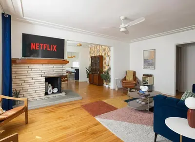 a living room with a fireplace and a couch at Modern Retro Close to DT, Zoo, Parking, Hot Tub in San Diego