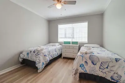 a bedroom with two beds and a window at Half block to bay steps to ocean AC large patio in San Diego